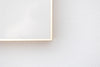 Closeup of Gold Metallic frame corner on white wall