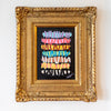 Framed artwork with colorful abstract design on a white wall
