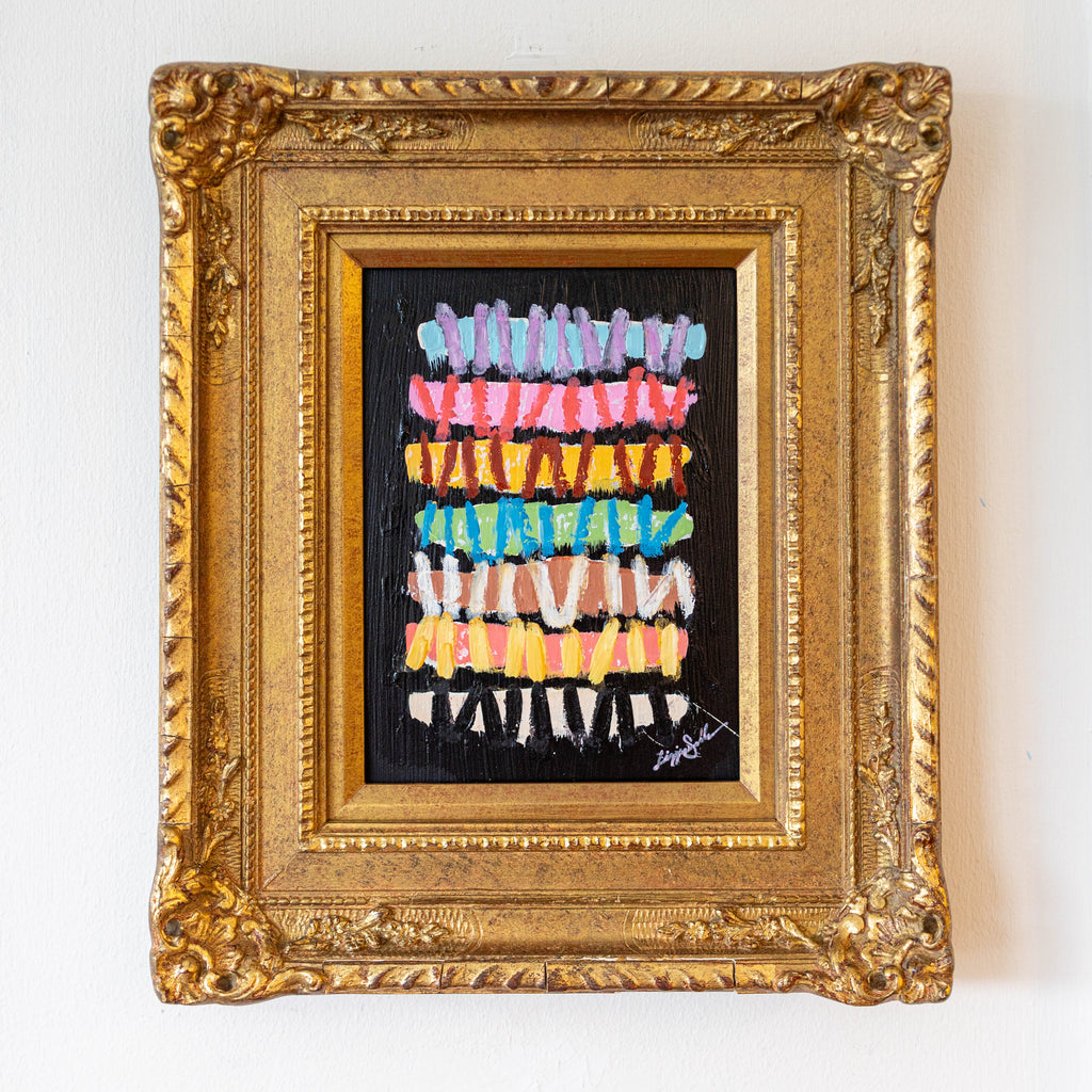 Framed artwork with colorful abstract design on a white wall