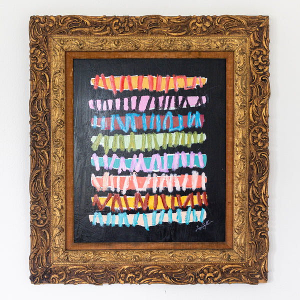 Framed abstract artwork with colorful horizontal stripes on a black background