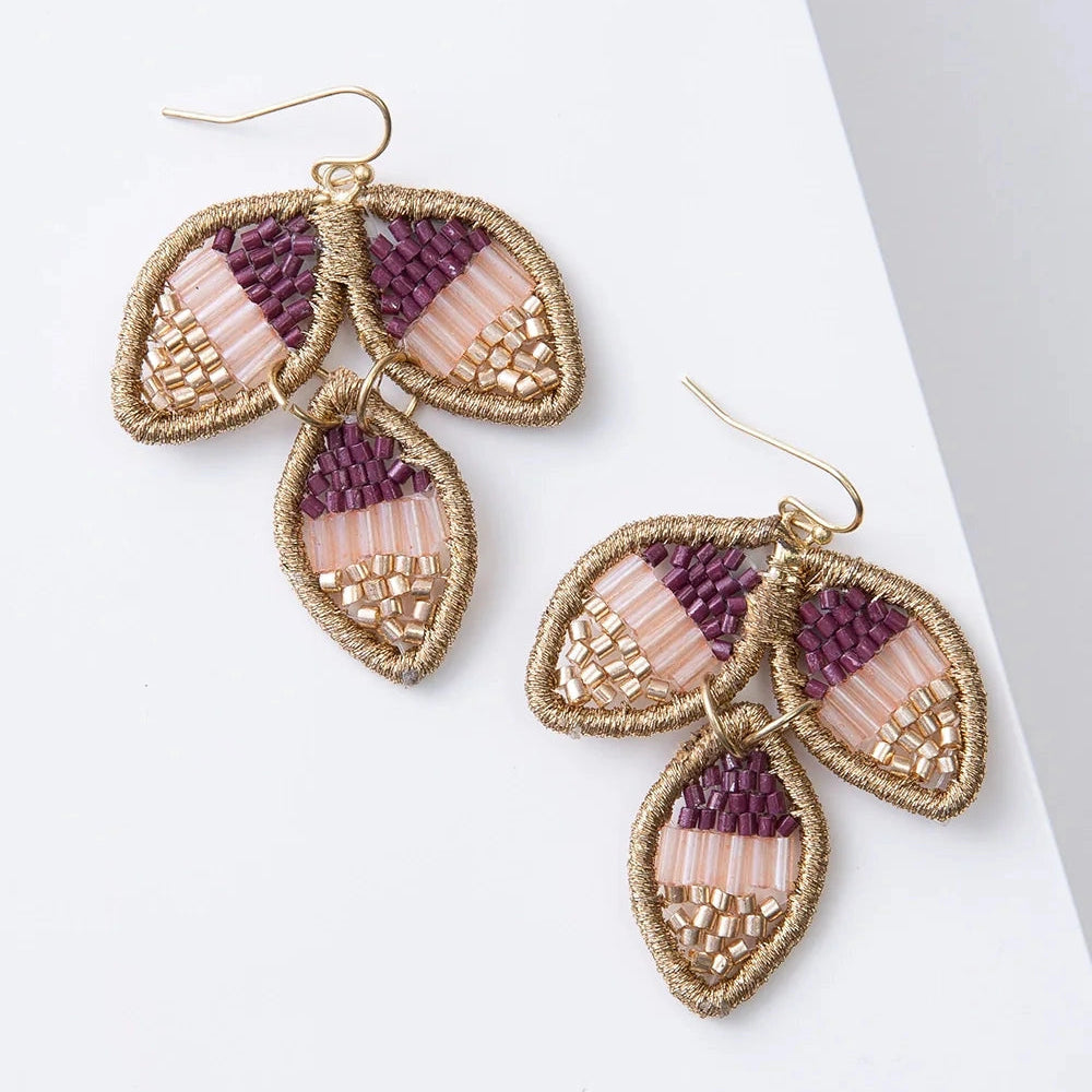 Pair of earrings with leaf-shaped design on a white background