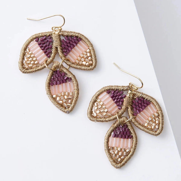 Pair of earrings with leaf-shaped design on a white background
