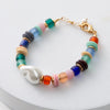 Colorful beaded bracelet with a gold clasp on a white background