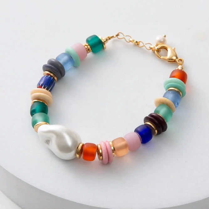 Colorful beaded bracelet with a gold clasp on a white background