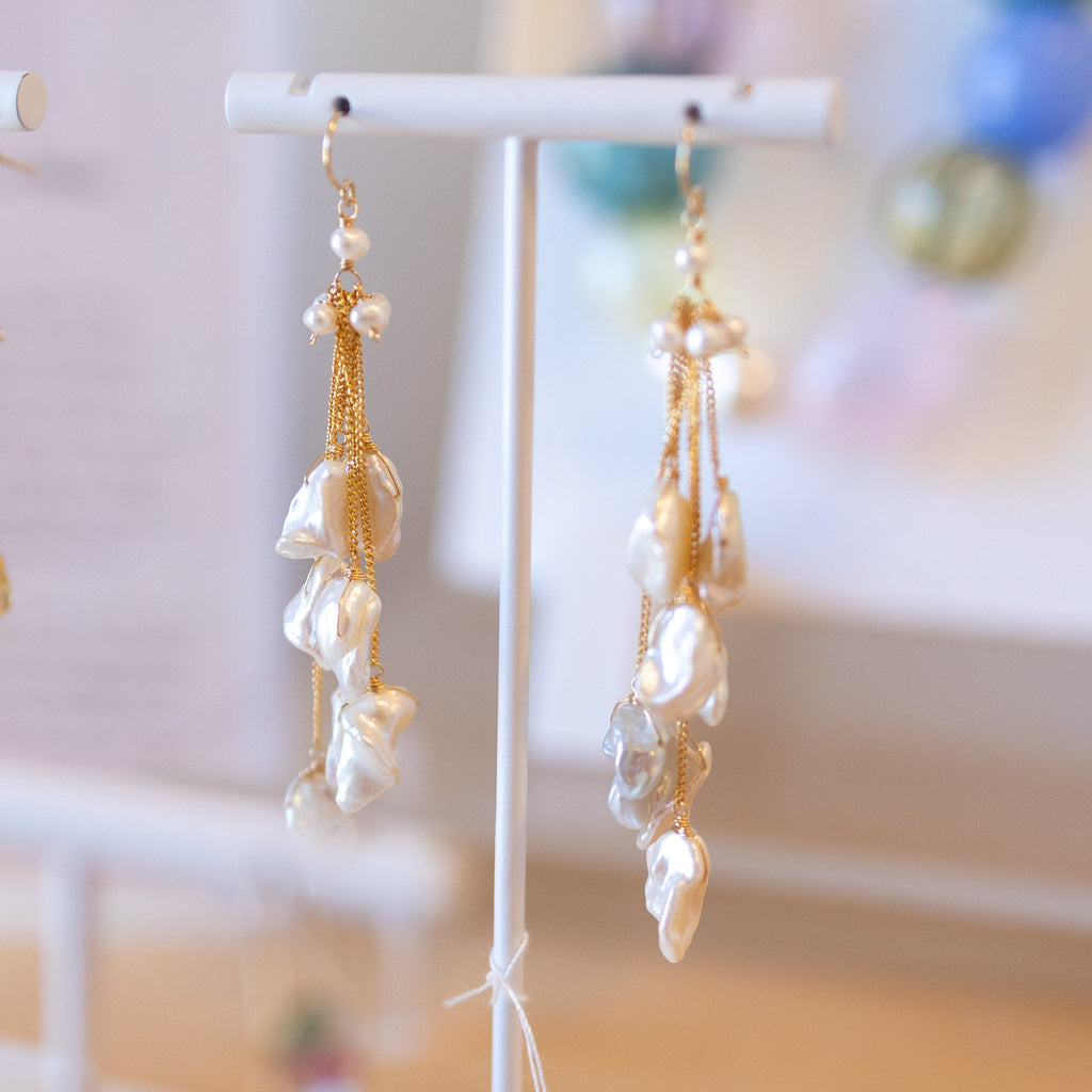 Earrings on display stands with a blurred background