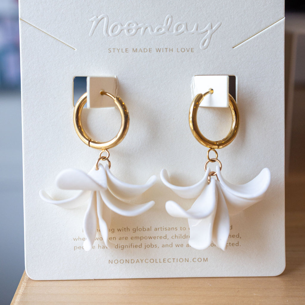 Gold hoop earrings on a white card with 'Noonday' branding.