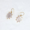 Pair of earrings with gold accents on a white background
