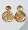 Pair of gold earrings with textured design on a light gray background